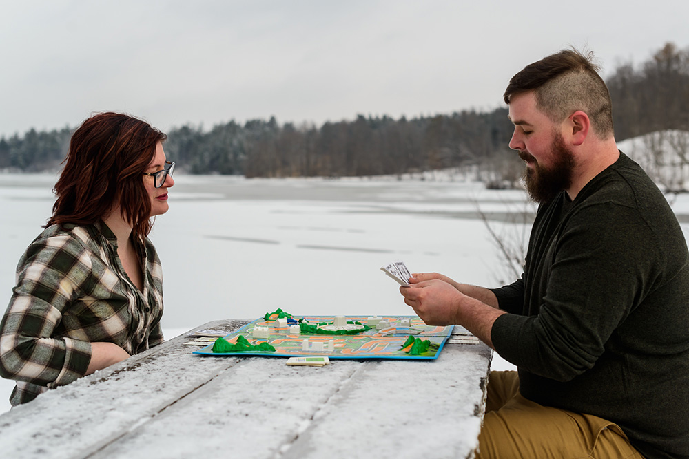 Couple playing board games outside in winter